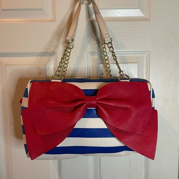 Betsey Johnson Handbags - Betsey Johnson white and Bleu stripes Satchel with large red bow accent .